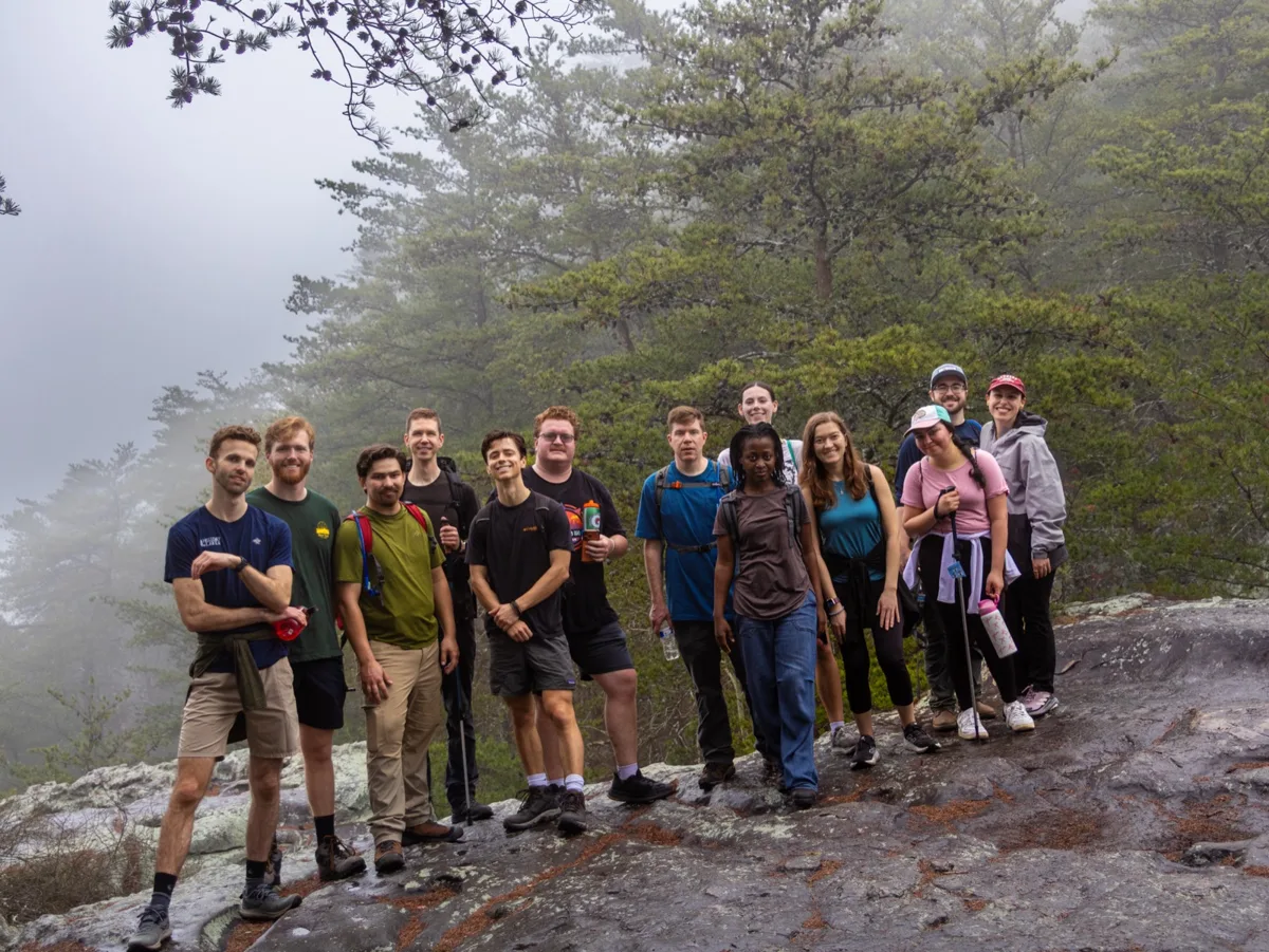 Friends taking a break on a foggy mountain hike